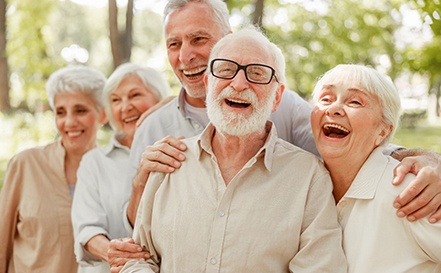 Multiple senior men and women outside and smiling