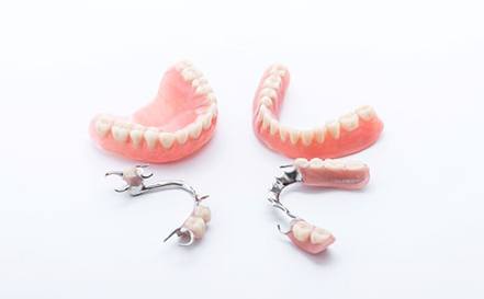 Full and partial dentures against white background