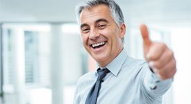 Business man giving thumbs up on blue-white background 