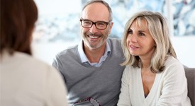 man and woman talking to their implant dentist in San Antonio 