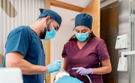 Dentist and team member treating dental patient