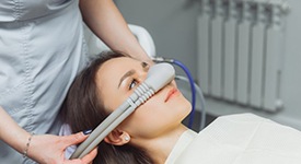 Lady is fitted with nitrous oxide mask
