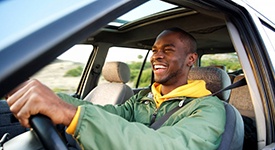 Man smiles while driving