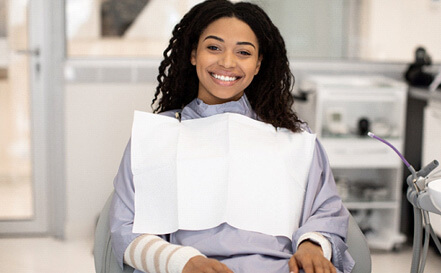 woman sitting in dental chair waiting for saturday dentist