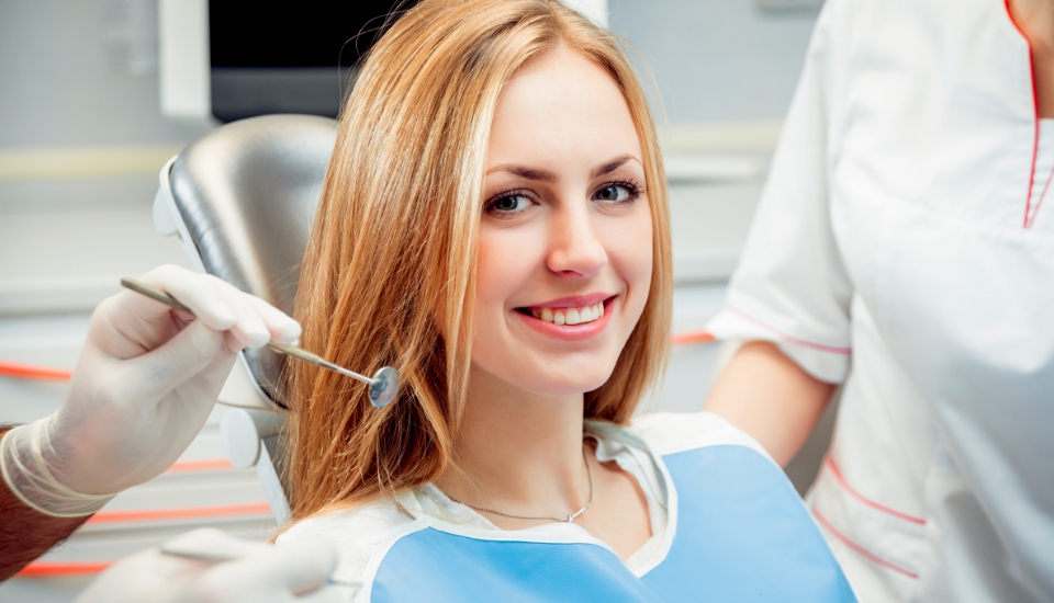 Woman in dental chair smiling