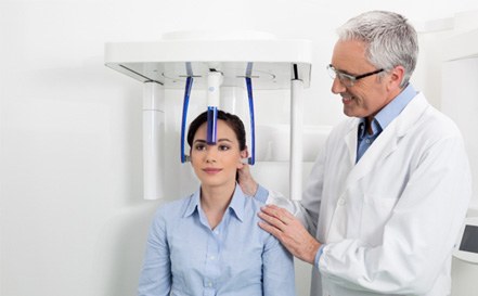 dentist using CBCT scanner with patient 